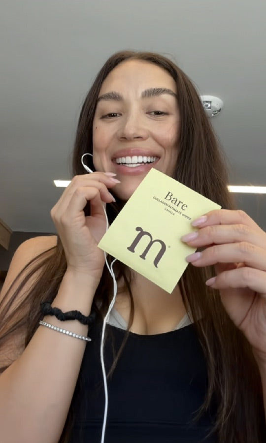 A smiling customer holding a Bare sachet