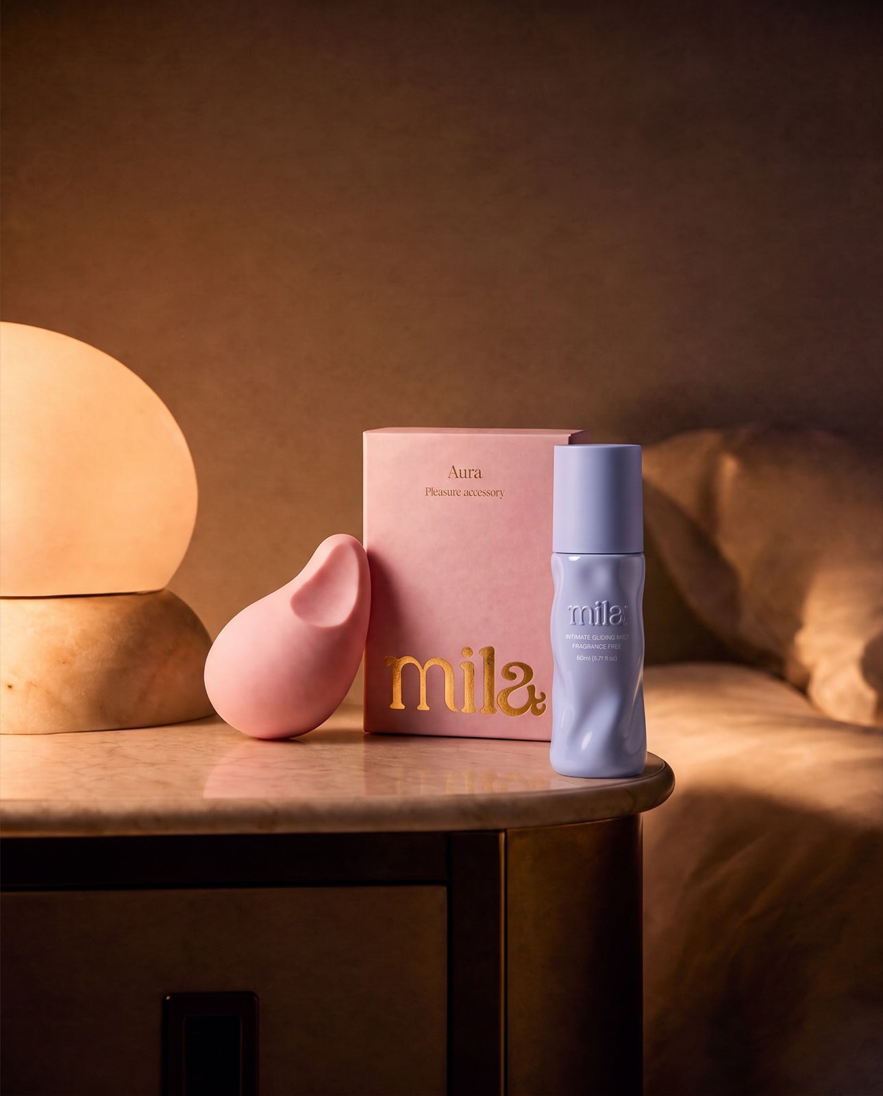 Aura and Bloom on a bedside table in warm lamplight