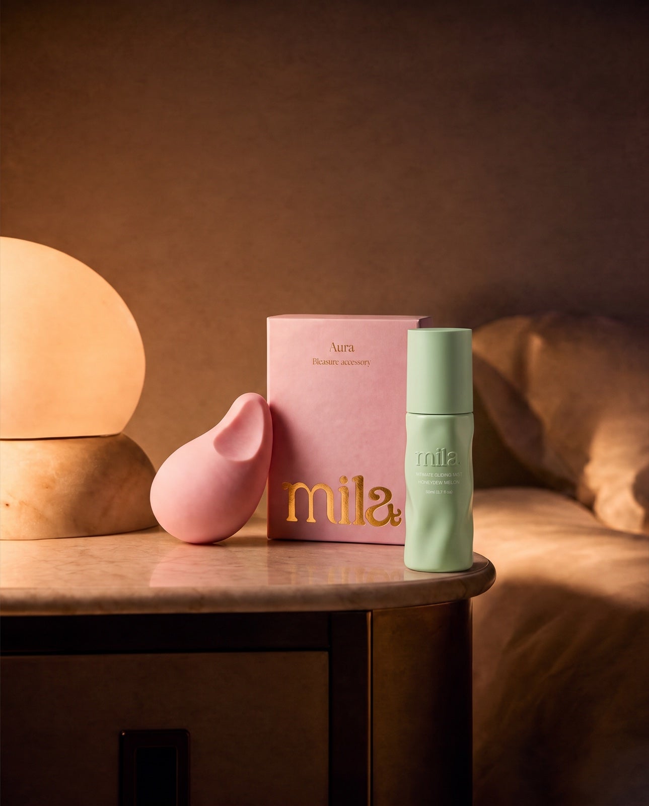 Aura and Bloom on a bedside table in warm lamplight