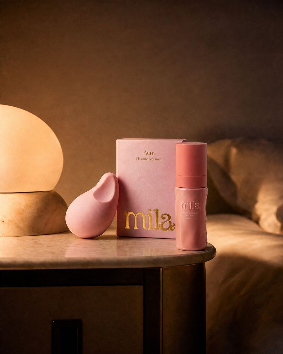 Aura and Bloom on a bedside table in warm lamplight